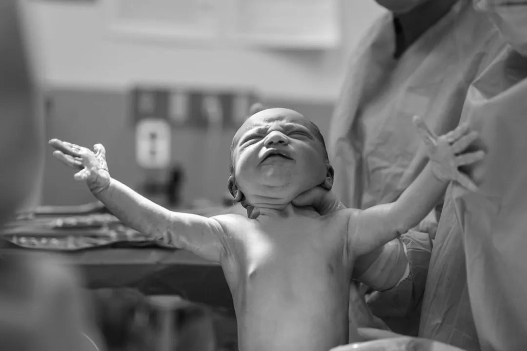 A newborn baby moments after birth — the reason good coverage matters